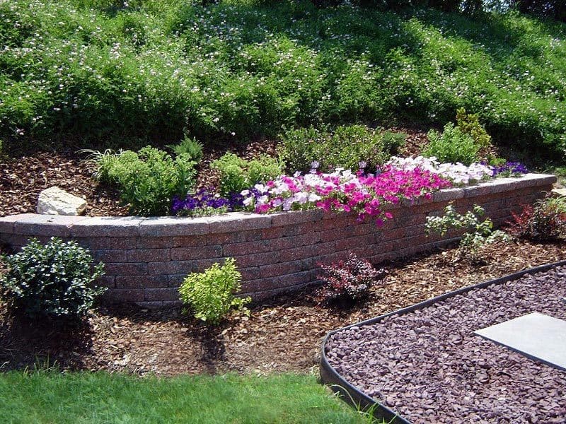 brick landscaping wall with flower bed