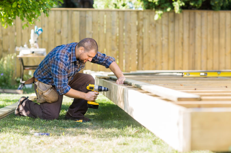 contractor working on construction of deck