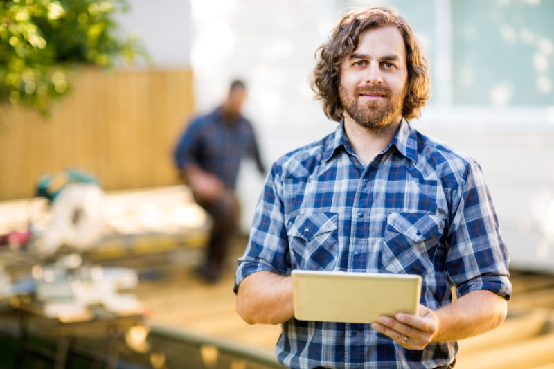 deck builder reviewing construction plan