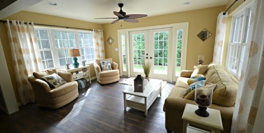 A newly remodeled living room with hardwood floors and glass doors